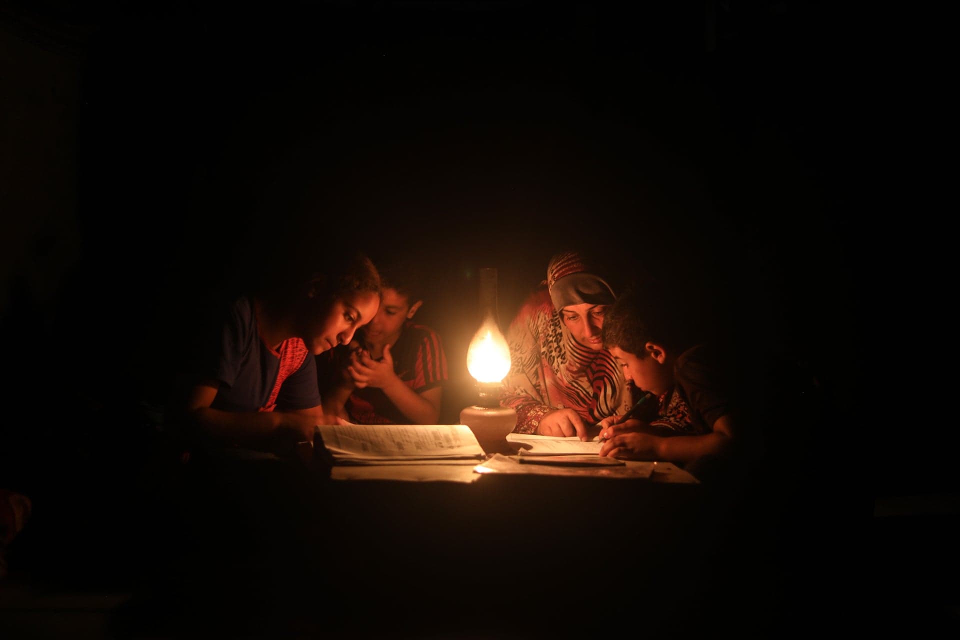 A family gathered around candlelight